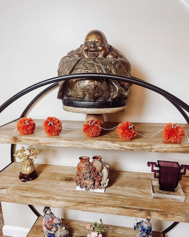 Buddha Showcase Enhanced with Garlands